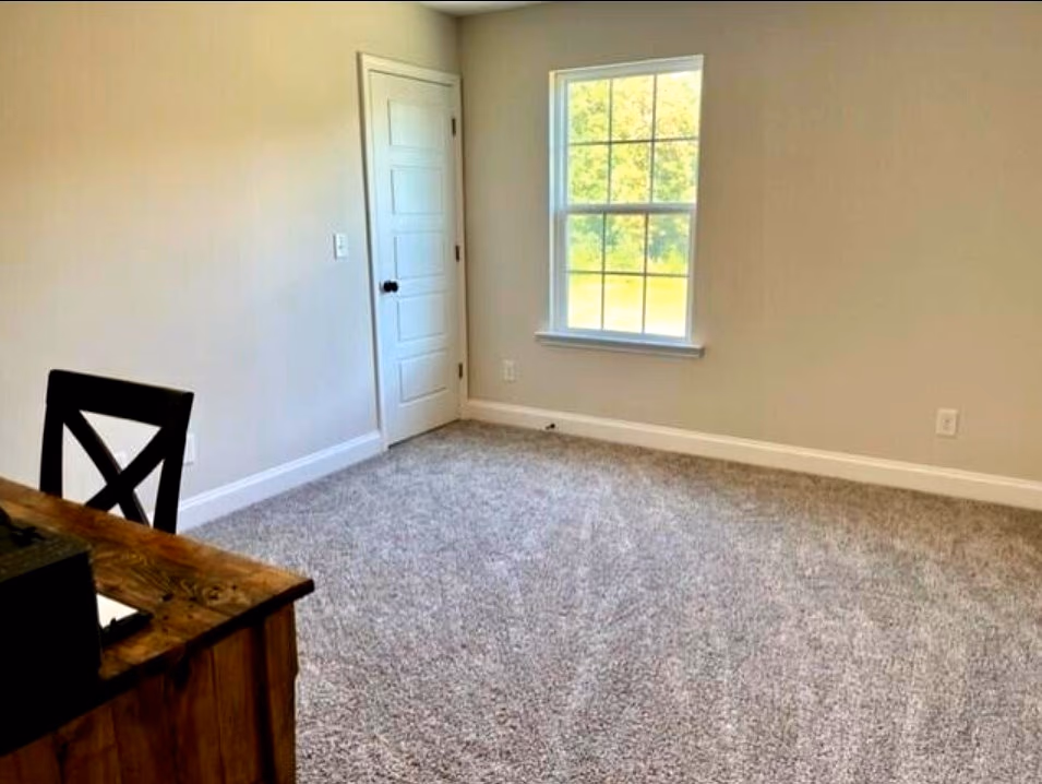 Secondary bedroom with fresh carpet and large picture window