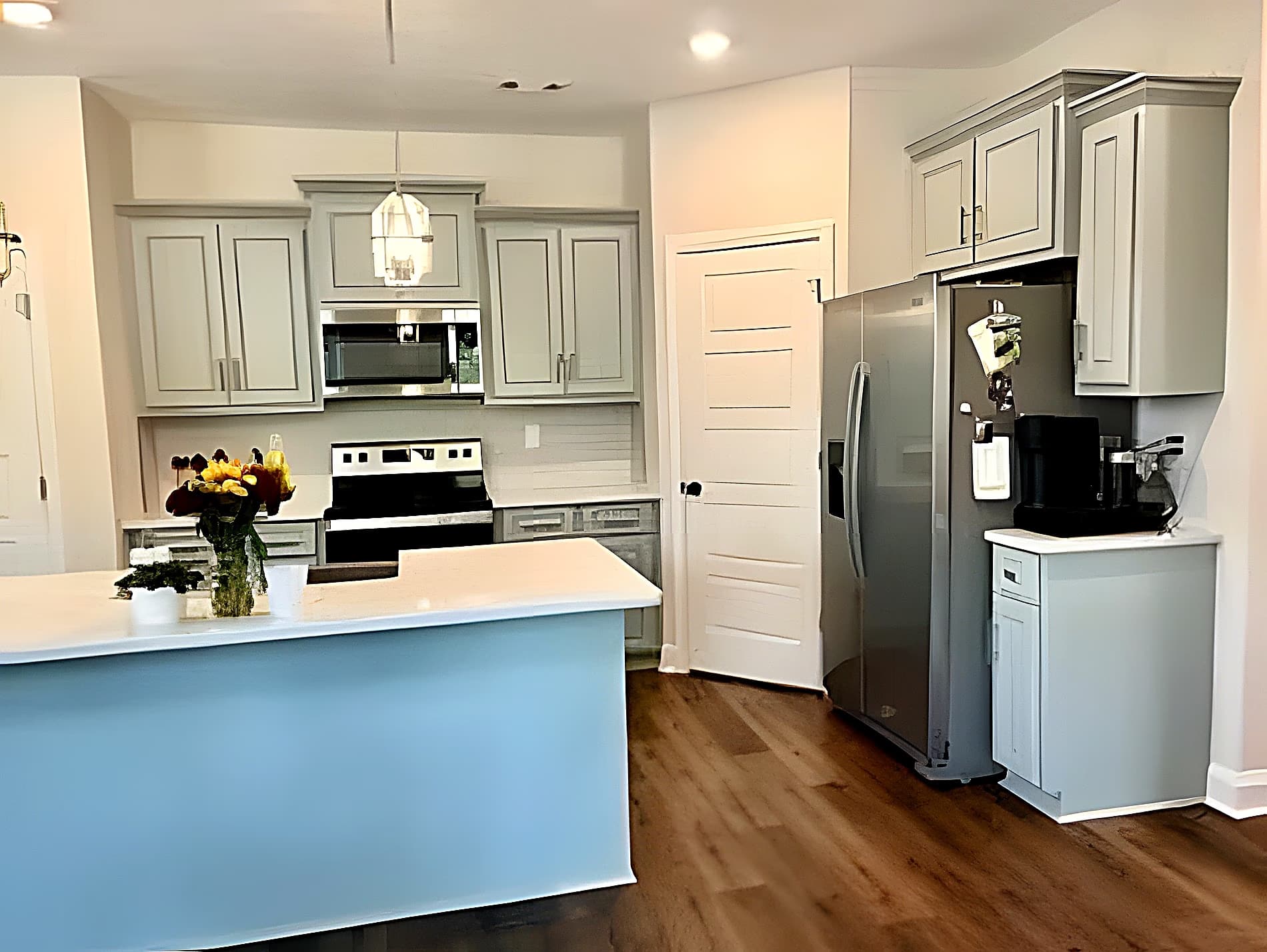 Kitchen with pantry, stainless fridge, and shiplap backsplash