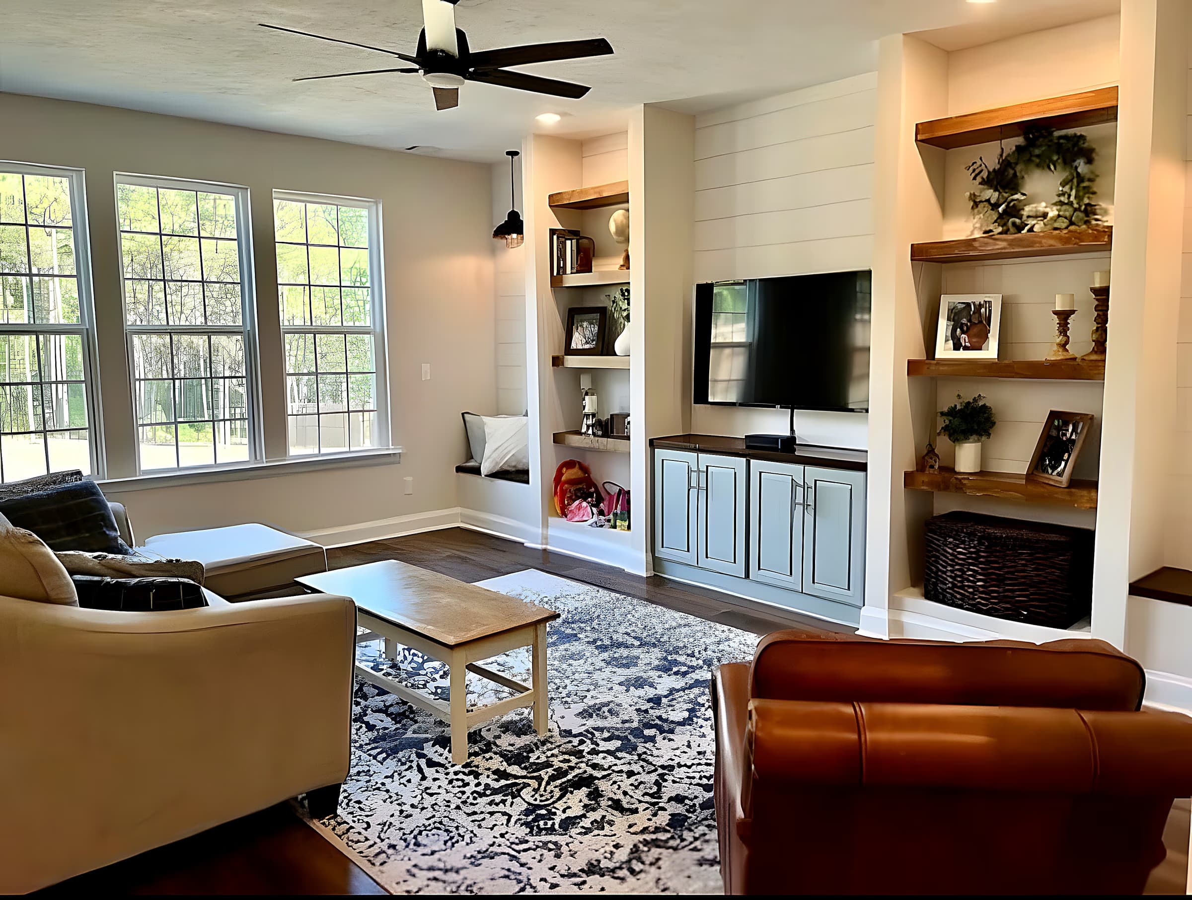 Great room with custom shiplap built-ins, floating shelves, and mounted TV