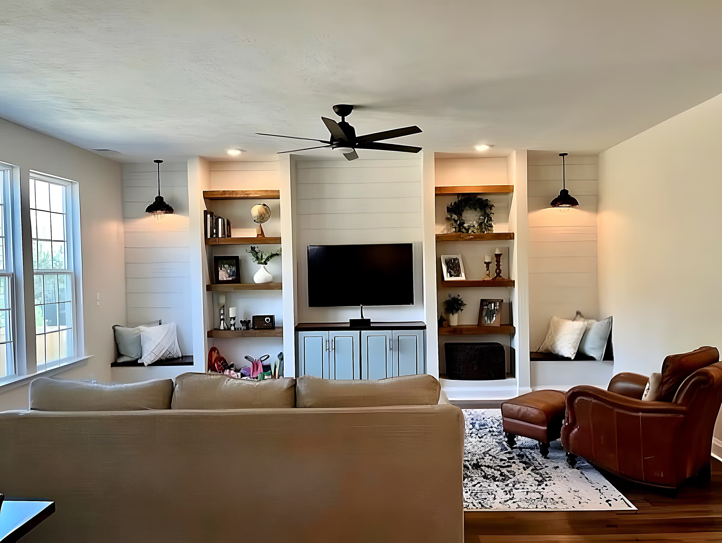 Great room with twin window benches, shiplap built-ins, and leather seating