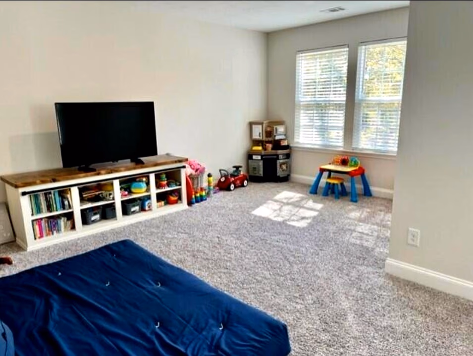 Upstairs bonus room with space for play, media, and lounging