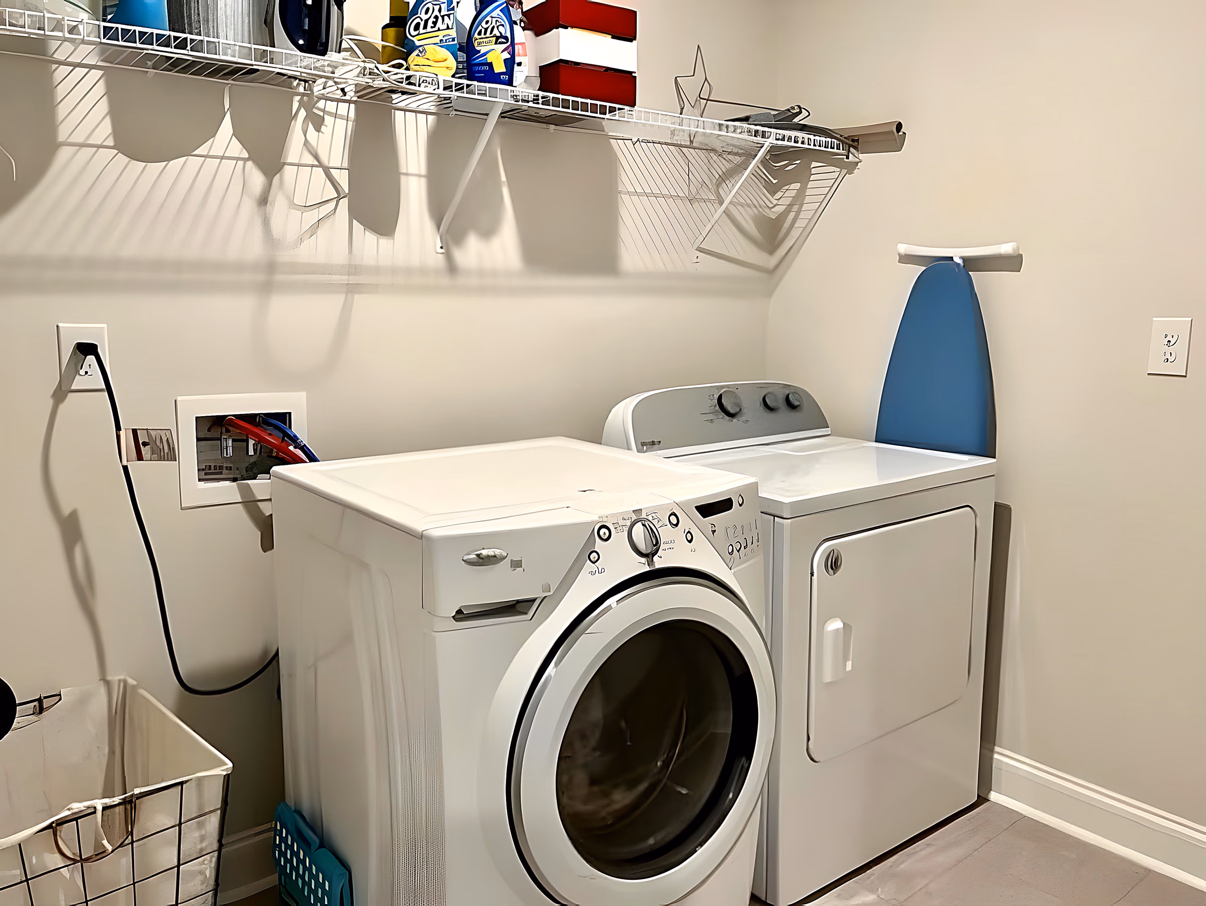 Laundry room with full-size washer, dryer, and wire shelving