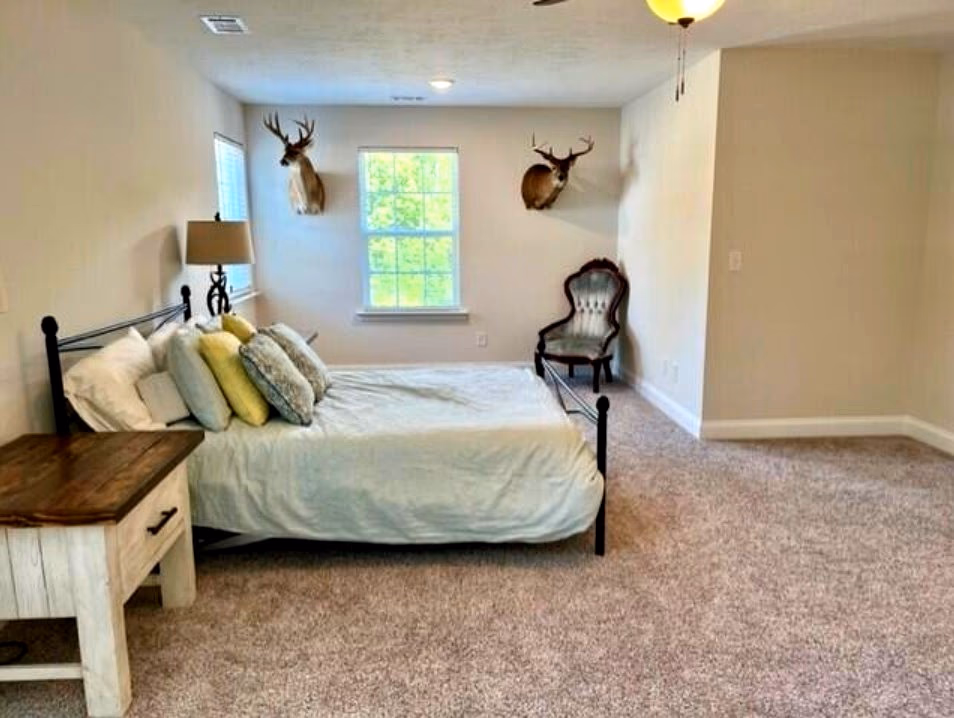 Primary bedroom sitting area with natural light